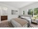 Bright bedroom with a large window, a bathroom sink, and a bed with two matching nightstands at 4206 W North B St # 1, Tampa, FL 33609