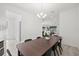 An open-concept dining room showcasing an elegant chandelier and a large wood table with seating at 4206 W North B St # 1, Tampa, FL 33609