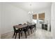 Bright dining room featuring a modern chandelier and a dark wood dining table with seating for six at 4206 W North B St # 1, Tampa, FL 33609