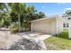 Exterior shot of the detached garage with neutral color scheme and a concrete driveway at 4206 W North B St # 1, Tampa, FL 33609