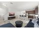 Inviting living room with tile flooring, a comfy blue sofa, and a view of the kitchen area at 4206 W North B St # 1, Tampa, FL 33609