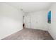 An empty bedroom is shown with neutral paint, carpet flooring, and two entry doors at 4206 W North B St # 2, Tampa, FL 33609