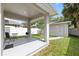 Covered patio area includes table, chair, and grill, perfect for outdoor dining and entertaining at 4206 W North B St # 2, Tampa, FL 33609