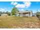 Backyard featuring well-maintained grass, partial fence, and patio at 4342 Candler Ave, Spring Hill, FL 34609