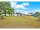 Backyard featuring well-maintained grass, partial fence, and a storage shed at 4342 Candler Ave, Spring Hill, FL 34609