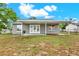 The backyard features well-maintained grass, partial fence, and patio at 4342 Candler Ave, Spring Hill, FL 34609