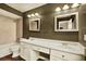 Well-lit bathroom with double sinks and large mirrors at 4342 Candler Ave, Spring Hill, FL 34609