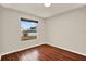 Clean bedroom featuring wood floors and a view outside at 4342 Candler Ave, Spring Hill, FL 34609