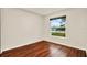 Bright bedroom with wood floors and view to outside at 4342 Candler Ave, Spring Hill, FL 34609
