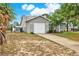 Single-story home with a large driveway and a two-car garage at 4342 Candler Ave, Spring Hill, FL 34609
