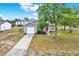 Beautiful single-story home with a red front door and mature trees at 4342 Candler Ave, Spring Hill, FL 34609