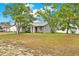 Charming single-story home with a well-manicured lawn and mature trees at 4342 Candler Ave, Spring Hill, FL 34609