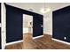 Spacious living room featuring hardwood floors and blue accent wall at 4342 Candler Ave, Spring Hill, FL 34609