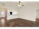 Spacious living room with hardwood floors, high ceilings, and an open view into the kitchen at 4342 Candler Ave, Spring Hill, FL 34609