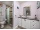 The bathroom features a shower with stone-look tiles, white cabinets, and a granite countertop at 460 Meravan Dr, Palm Harbor, FL 34683