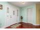 Inviting entryway with hardwood floors, a stylish front door with decorative glass and fresh, clean paint at 460 Meravan Dr, Palm Harbor, FL 34683