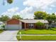 Charming single-story home with well-maintained lawn and landscaping, featuring a two-car garage at 460 Meravan Dr, Palm Harbor, FL 34683