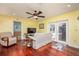 Cozy Gathering room with hardwood floors, comfortable seating, and French doors leading to outdoor space at 460 Meravan Dr, Palm Harbor, FL 34683