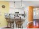 Bright kitchen featuring white cabinets, stainless steel appliances, and a breakfast bar with seating at 460 Meravan Dr, Palm Harbor, FL 34683