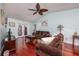 Cozy living room featuring hardwood floors, comfortable seating, and French doors leading to the pool area at 460 Meravan Dr, Palm Harbor, FL 34683