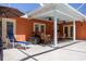 This screened-in patio includes seating, ceiling fans, an umbrella, and pool access at 460 Meravan Dr, Palm Harbor, FL 34683