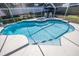 A beautiful screened-in pool includes an attached hot tub and a large deck at 460 Meravan Dr, Palm Harbor, FL 34683