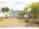 Backyard with tropical plants, and an inviting fire pit surrounded by lush greenery at 4830 47Th N Ave, St Petersburg, FL 33714