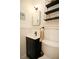 Stylish half-bathroom features black fixtures and decorative tile floor at 4830 47Th N Ave, St Petersburg, FL 33714