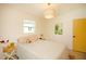 Bright bedroom with a lamp lit on a side table and view to a door at 4830 47Th N Ave, St Petersburg, FL 33714