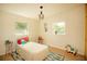 Bright bedroom features wood floors, two windows and a modern ceiling light fixture at 4830 47Th N Ave, St Petersburg, FL 33714