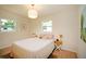 Cozy bedroom with a view to the outdoors, hardwood floors, and neutral decor at 4830 47Th N Ave, St Petersburg, FL 33714