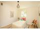 Bedroom with wooden floors, flamingo print, and a window that lets in natural light at 4830 47Th N Ave, St Petersburg, FL 33714