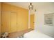 Bedroom with yellow wardrobe and door, wooden floors and a fun flamingo print at 4830 47Th N Ave, St Petersburg, FL 33714