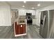 Updated kitchen featuring stainless steel appliances, white cabinets and wood-trimmed island at 4851 W Gandy Blvd # B10L30, Tampa, FL 33611