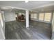 Open-concept living space featuring grey wood floors and neutral paint at 4851 W Gandy Blvd # B10L30, Tampa, FL 33611