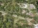 Overhead shot showing vast tree cover and winding roads to the secluded property at 5290 Cyril Dr, Dade City, FL 33523