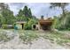 Backyard featuring outbuildings including storage sheds and a covered structure at 5290 Cyril Dr, Dade City, FL 33523
