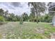 Large backyard featuring storage sheds, a covered structure, and ample space at 5290 Cyril Dr, Dade City, FL 33523