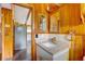 Updated bathroom features granite vanity, updated fixtures, and wood paneling at 5290 Cyril Dr, Dade City, FL 33523
