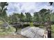 Waterfront lot featuring a weathered dock surrounded by lush trees and tranquil waters at 5290 Cyril Dr, Dade City, FL 33523