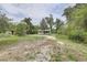 Quaint single-story home with a large unpaved front yard at 5290 Cyril Dr, Dade City, FL 33523