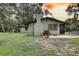 Quaint single story house with mature trees and a large chimney at 5290 Cyril Dr, Dade City, FL 33523