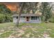Charming single-story home featuring a cozy front porch and well-maintained lawn, perfect for outdoor relaxation at 5290 Cyril Dr, Dade City, FL 33523