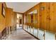Hallway with wood paneling, offering access to other rooms at 5290 Cyril Dr, Dade City, FL 33523