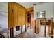 Hallway with wood paneling, offering access to other rooms at 5290 Cyril Dr, Dade City, FL 33523