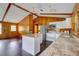 Kitchen features granite counters, stainless appliances, breakfast bar, and wood-paneled walls at 5290 Cyril Dr, Dade City, FL 33523