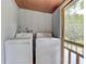 Laundry room equipped with a washer, dryer, and access to the outdoors at 5290 Cyril Dr, Dade City, FL 33523