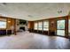 Spacious living room featuring a brick fireplace and a large window at 5290 Cyril Dr, Dade City, FL 33523