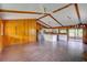 Open-concept living room featuring tiled floors, ceiling fans, and a sliding door to a screened-in porch at 5290 Cyril Dr, Dade City, FL 33523