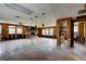 Spacious living room featuring a fireplace and large windows, offering a bright and inviting atmosphere for relaxation and entertainment at 5290 Cyril Dr, Dade City, FL 33523